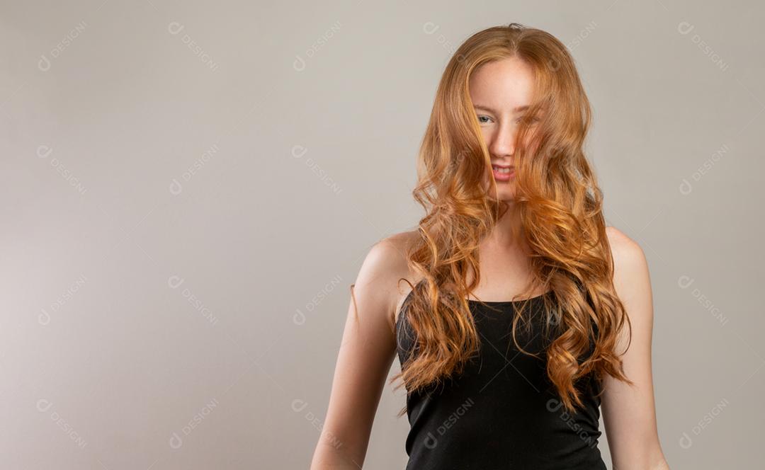 Portrait of beautiful cheerful redhead girl smiling laughing looking at camera over white background.