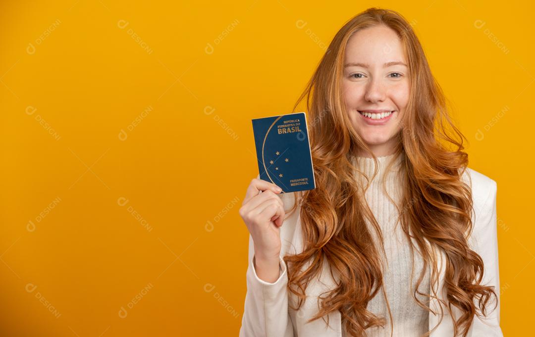 Linda ruiva de cabelos cacheados em viagens. Próxima viagem. Garota segurando passaporte brasileiro. Em amarelo.