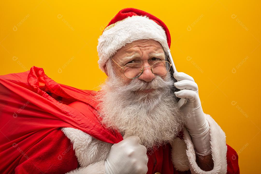 Papai Noel em chapéus, fantasia, faixa preta, luvas brancas traz presentes para crianças