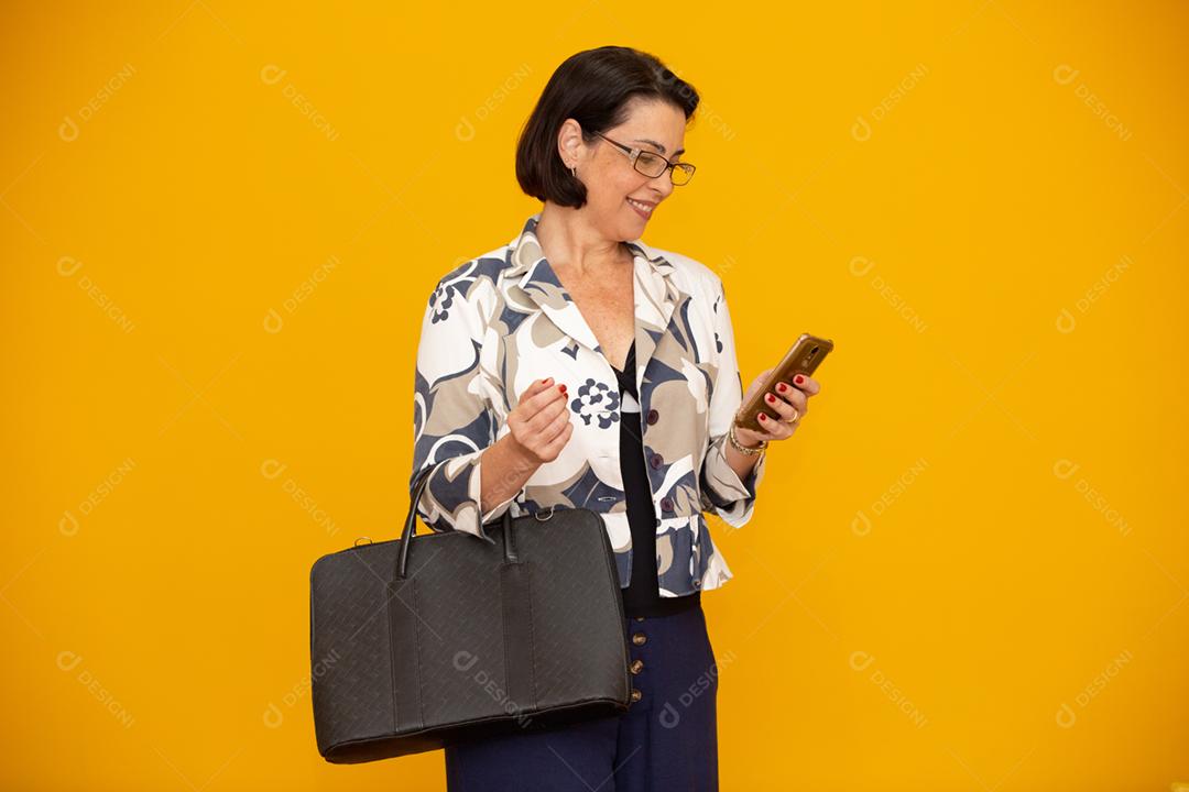 Foto de uma empresária madura atraente trabalhando com seu telefone celular