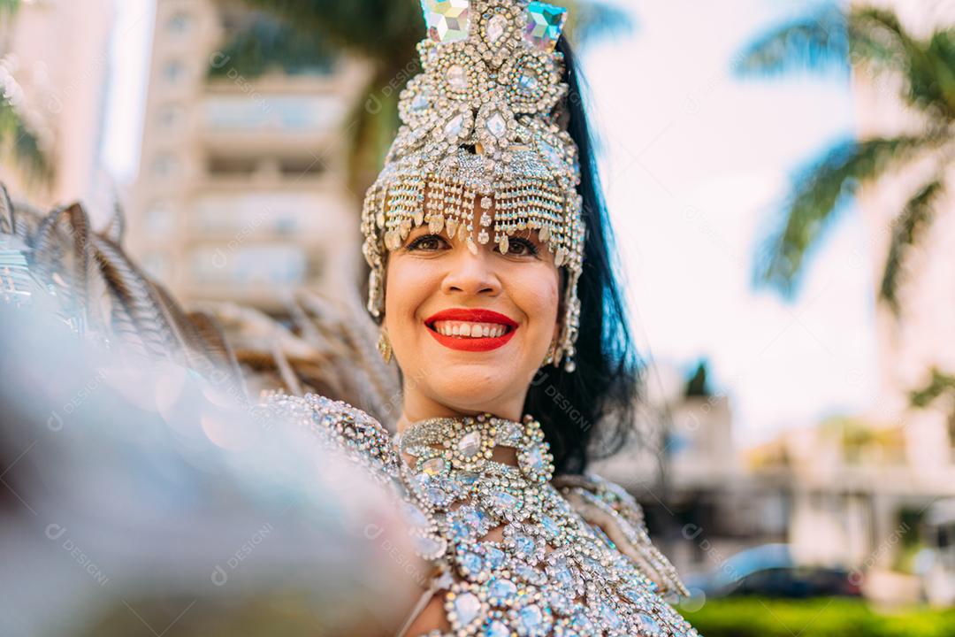 Linda mulher brasileira vestindo fantasia carnaval colorida e sorrindo durante o desfile de rua