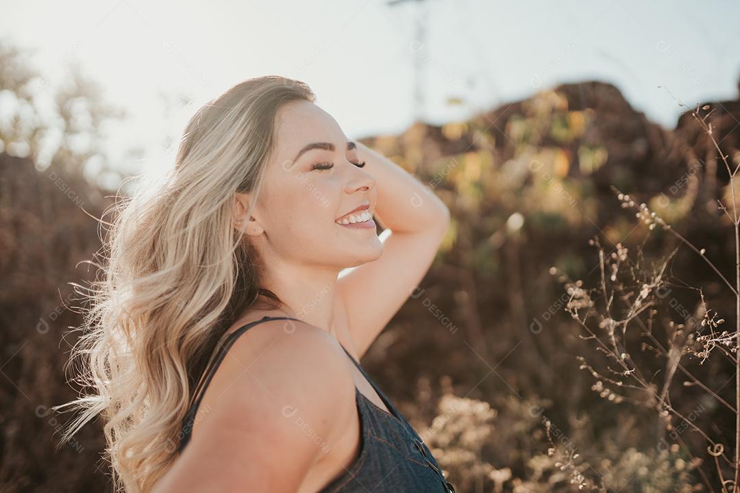 Outdoor portrait of beautiful young latin blonde woman. hair development