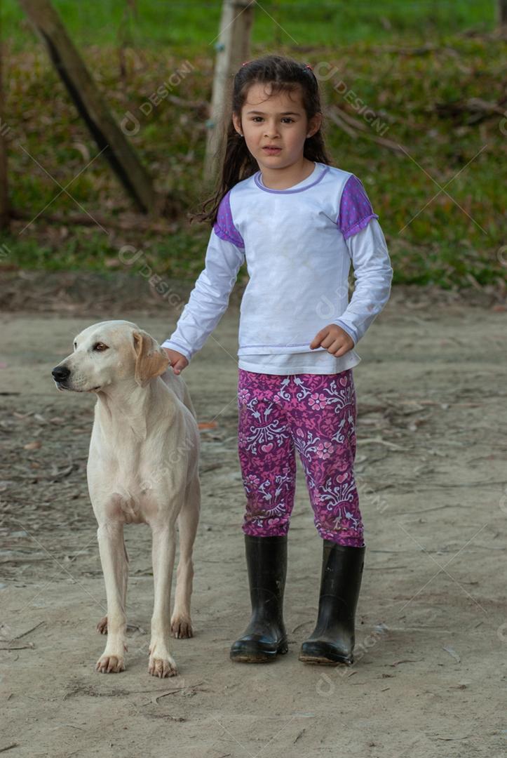 Beautiful portrait of a child petting a dog