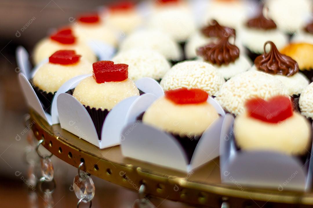 Doces brigadeiros sobre mesa de madeira