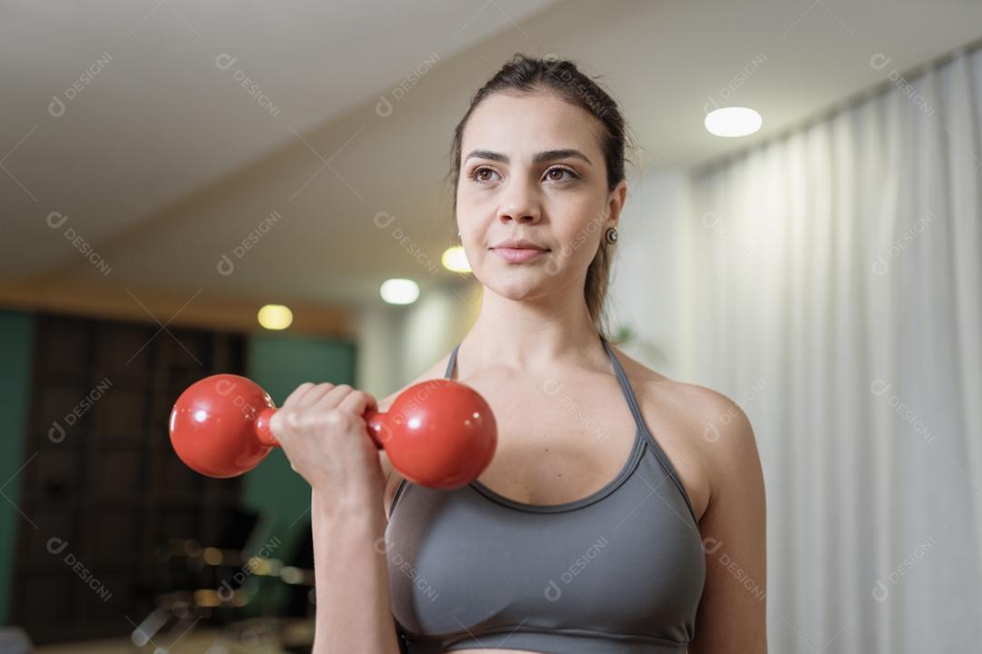 Attractive latin young woman exercising at home. Healthy lifestyle concept.