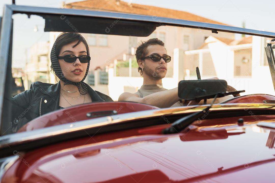 Amigos viajando juntos em um velho carro conversível. Verão