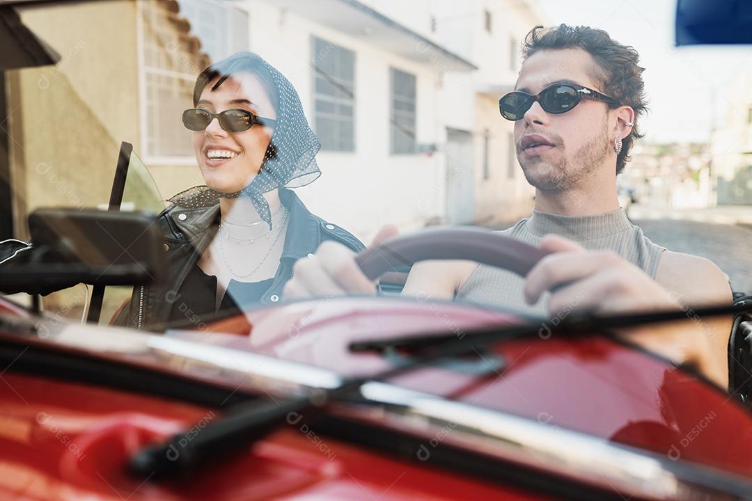 Friends traveling together in an old convertible car. Summer