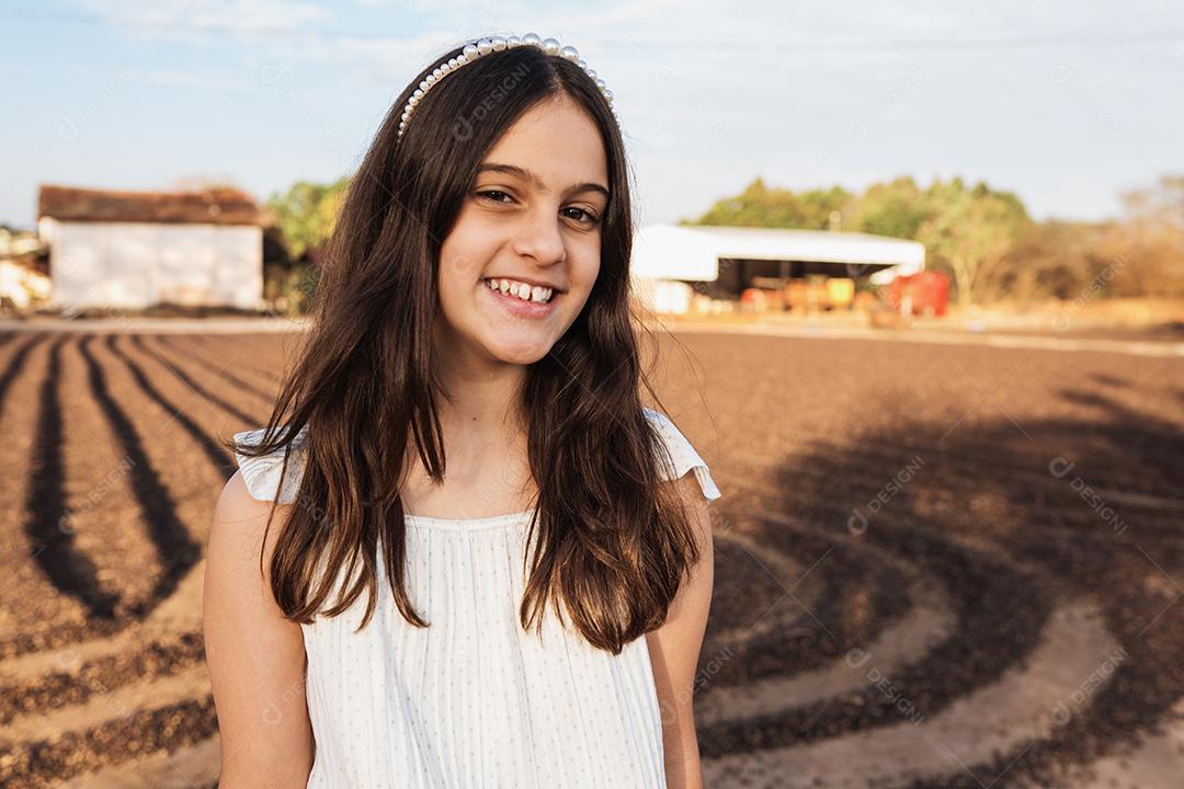 Happy beautiful child girl on coffee farm background.