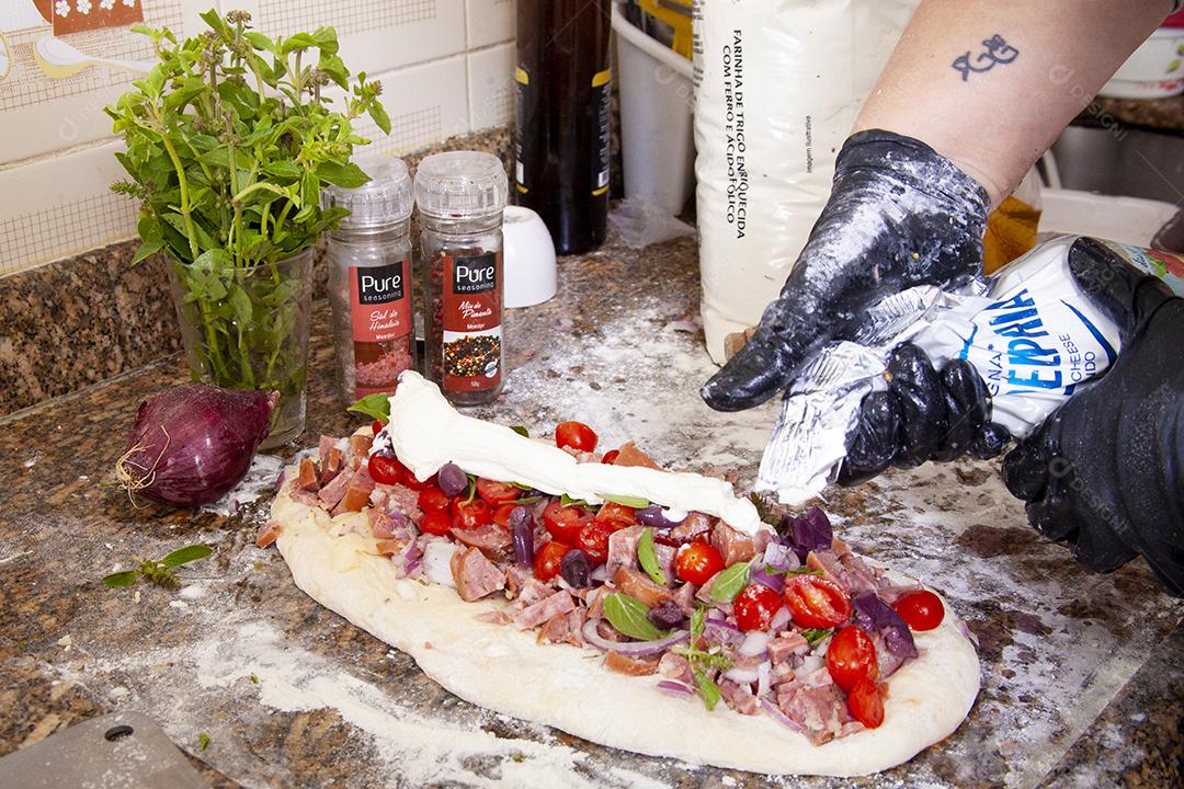 Person putting toppings on pizza food pizzerias