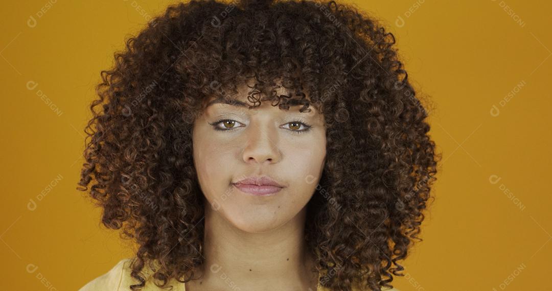 Linda modelo morena em amarelo. Cabelo encaracolado. jovem brasileira.