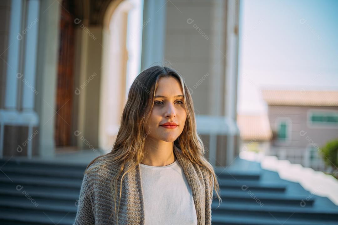 Outdoor portrait of young elegant elegant young Latina woman walking down the street in Brazil