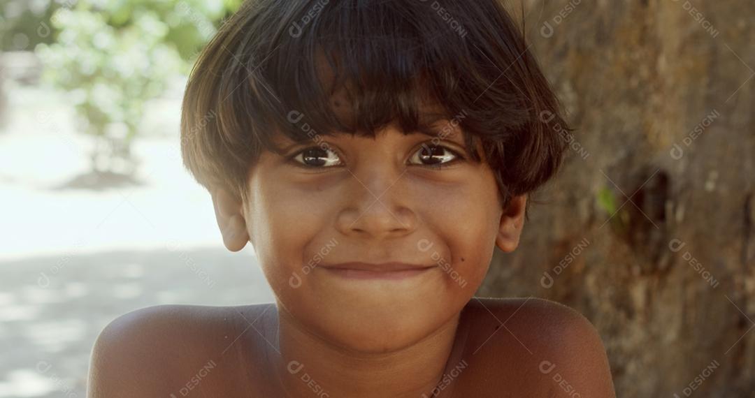 Jovem índio da tribo Pataxó do sul da Bahia. Criança indiana olhando para a direita