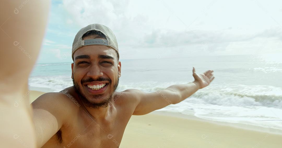 Friendly Latin American young man inviting to Brazil