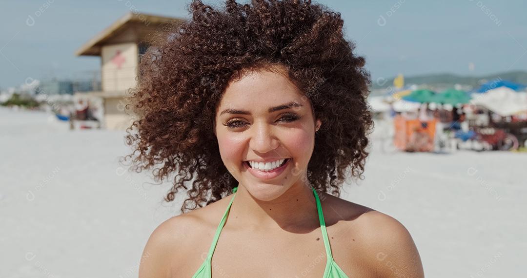 Beautiful Latin American woman on the beach. Young woman enjoying