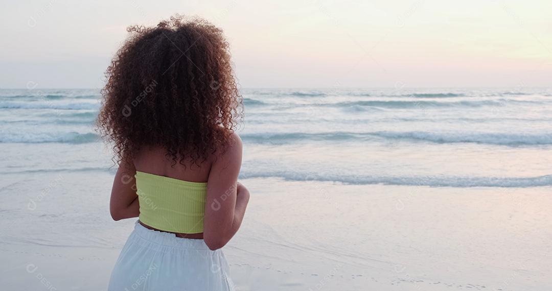 Beautiful Latin American woman on the beach. Young woman enjoying