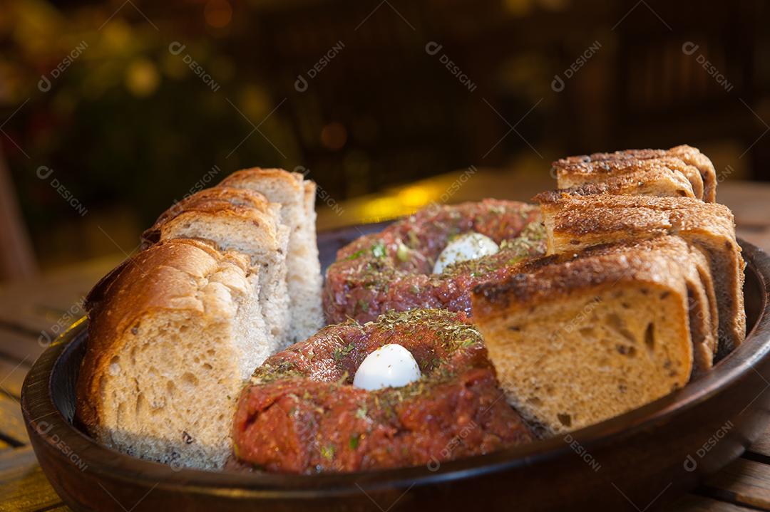 filé tártaro com pão, é um prato de carne de vaca ou de cavalo crua e finamente picada, misturada com vários condimentos e servida com uma gema de ovo crua.