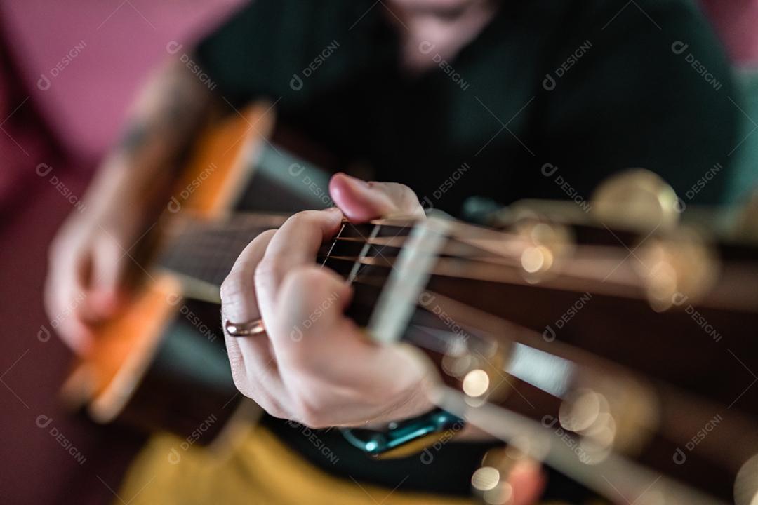 Homem tocando guitarra. Vista de perto