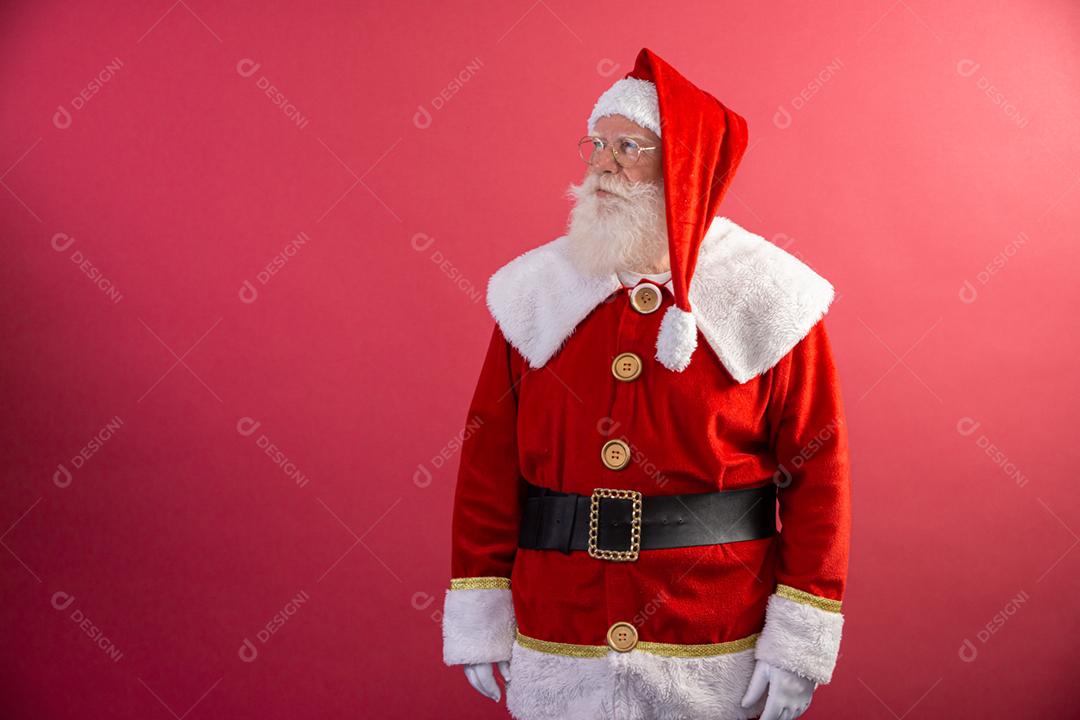 Verdadeiro Papai Noel com fundo vermelho, usando óculos, luvas e um chapéu ansioso
