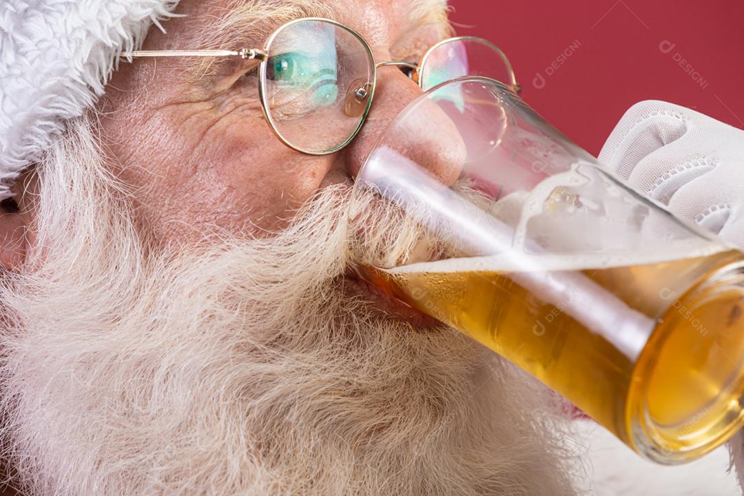 Papai Noel bebendo um copo de cerveja. Tempo de descanso. Bebida alcoólica nos feriados