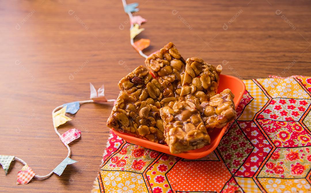 Pe de moleque, typical Brazilian peanut candy on a wooden table.
