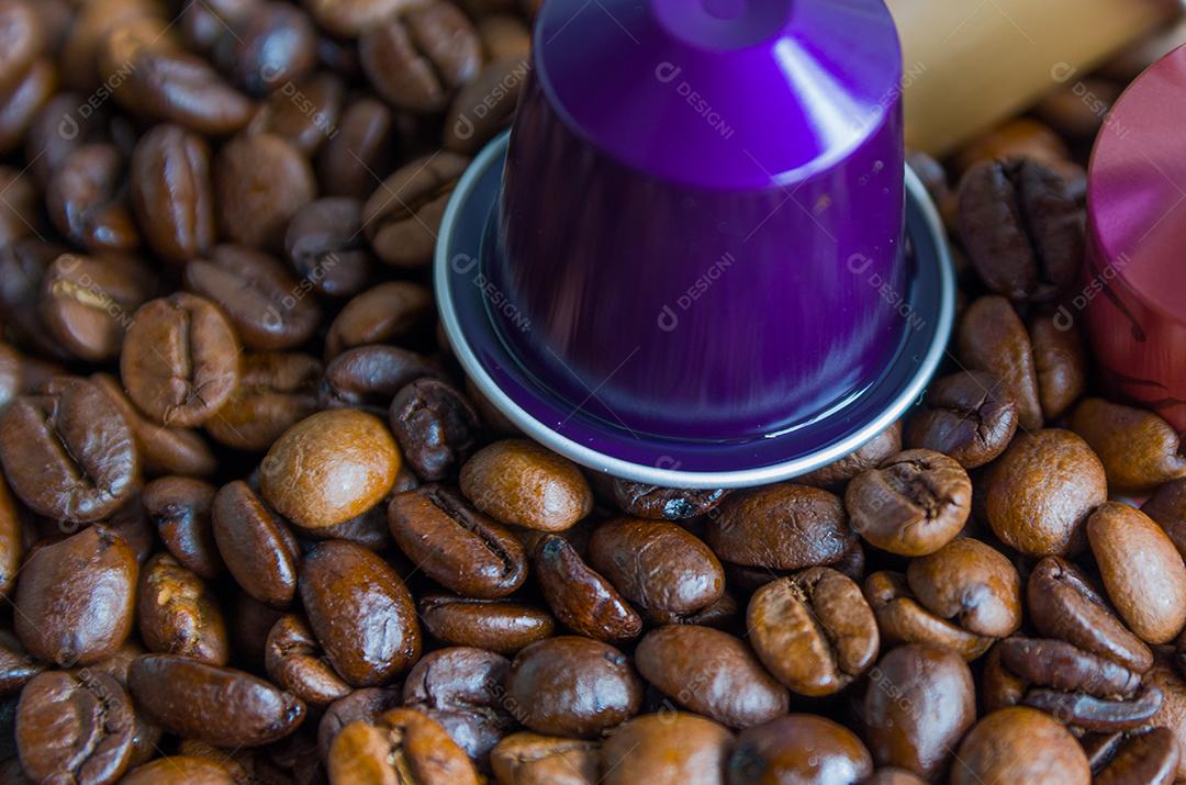 Um grupo de café em grão sobre fundo isolado com copo.