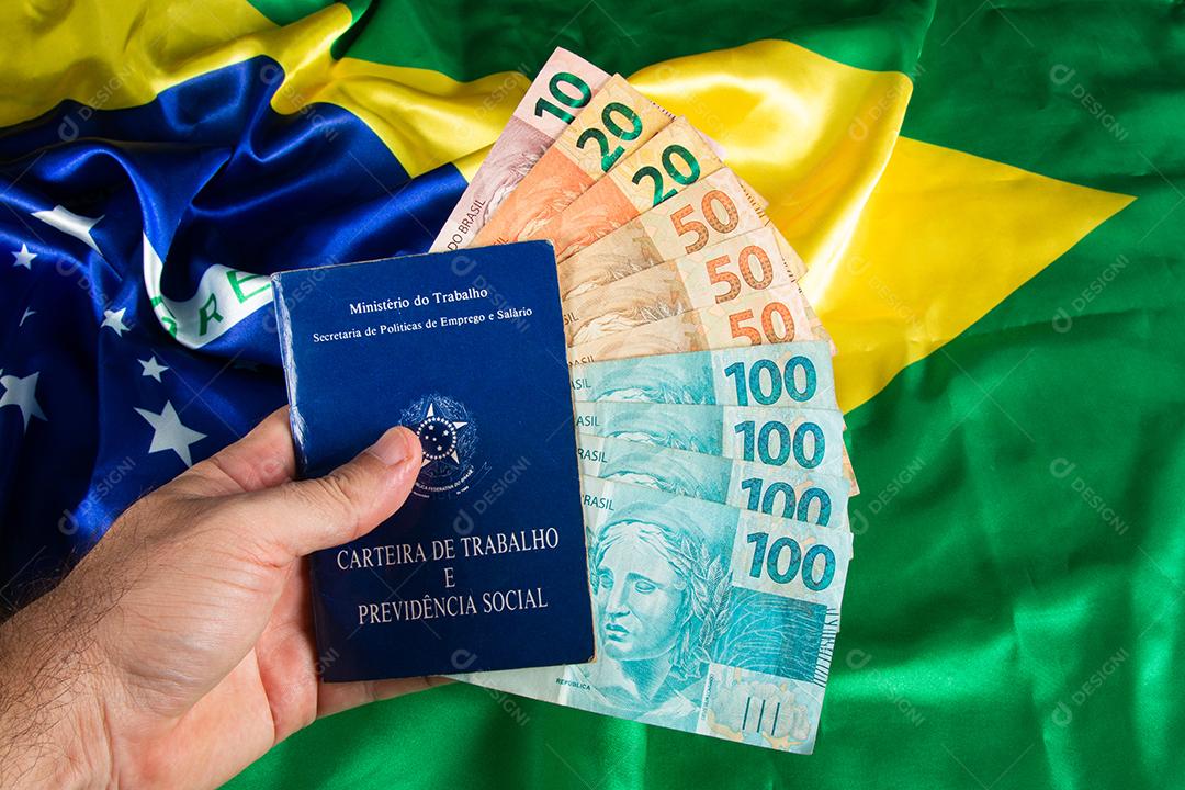 Mão segurando trabalho de documento brasileiro e previdência social (Carteira de trabalho)