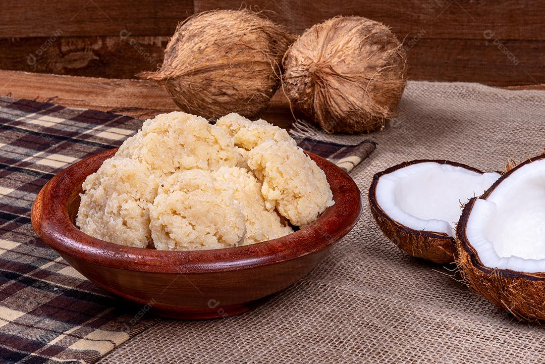 Coconut candy on wooden table. Traditional sweet from Brazil