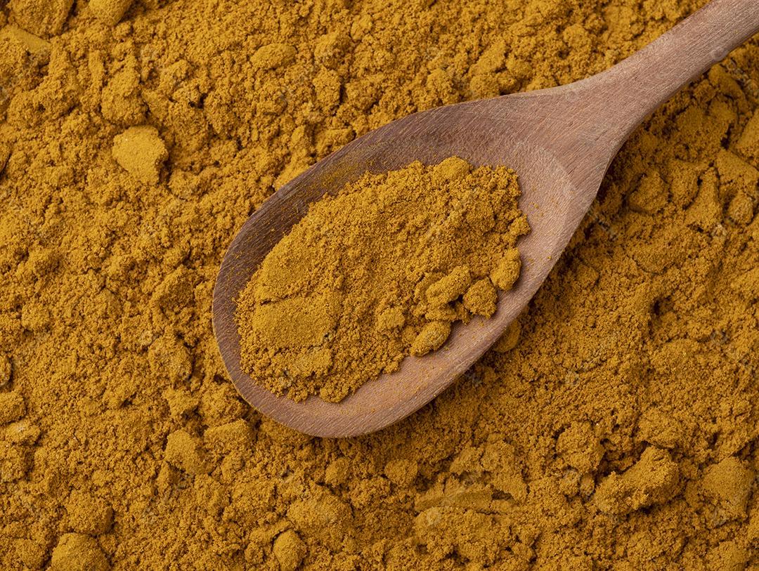Vista superior, cúrcuma em uma colher. Pano de fundo alimentar