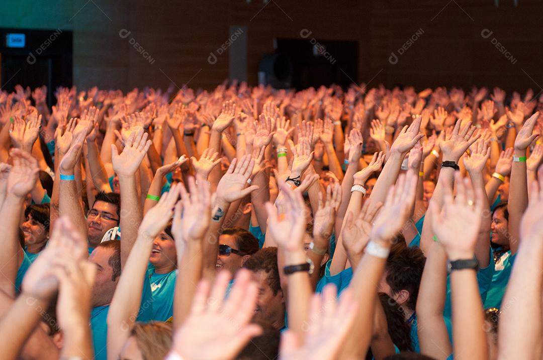 Várias pessoas á noite reunidas em um lugar, se divertindo. Pessoas.