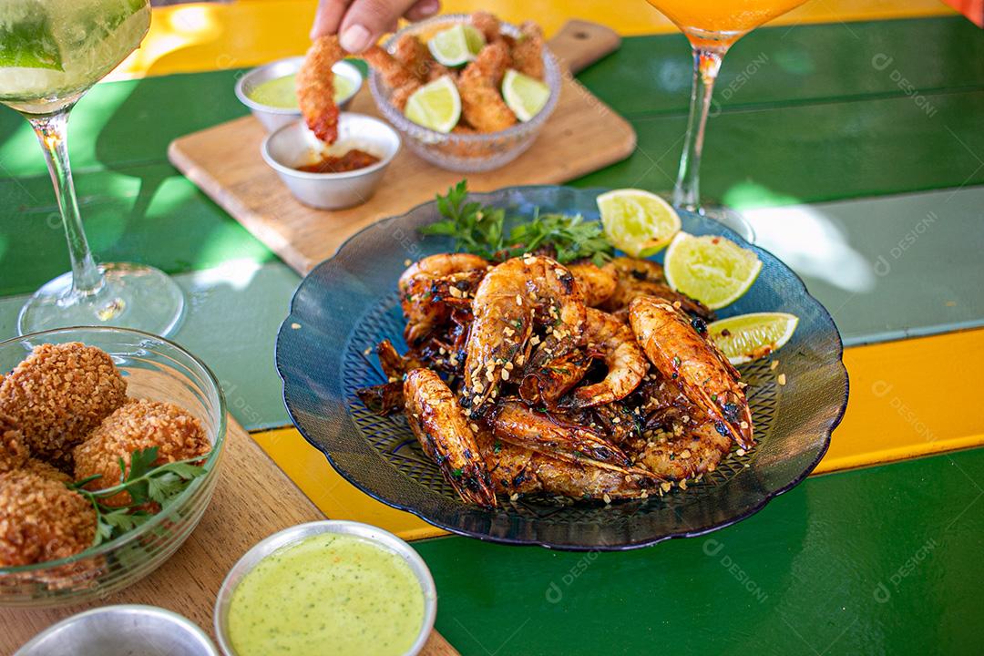 Dried shrimp on plate with lemons and coriander.