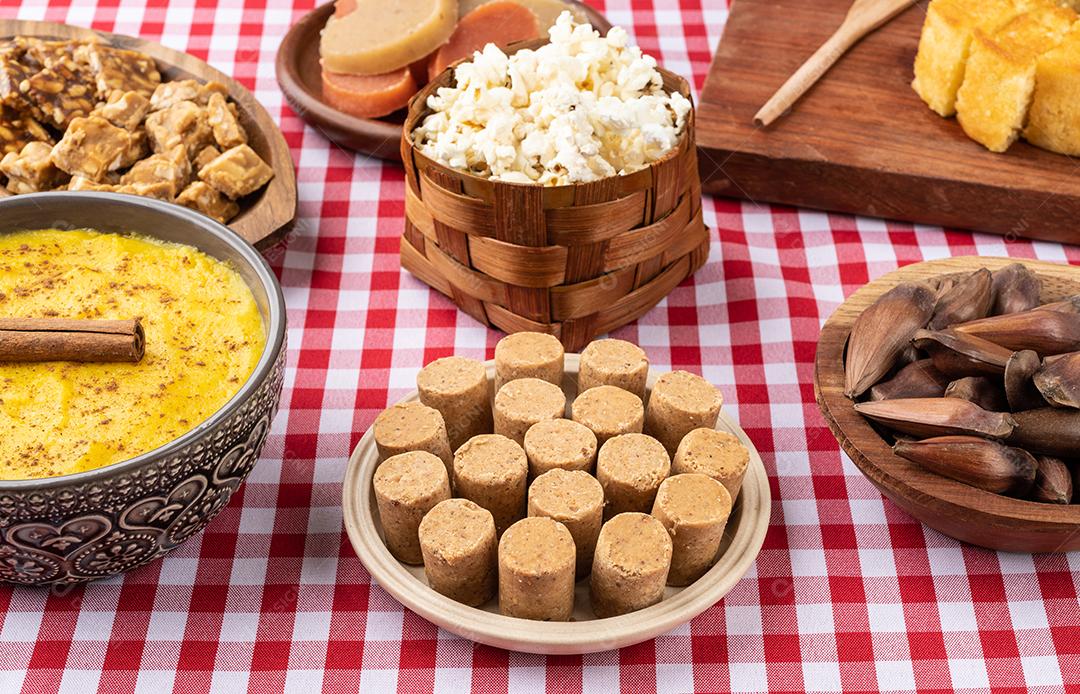 Comida típica do festival brasileiro de junho sobre tecido xadrez vermelho. Festa junina