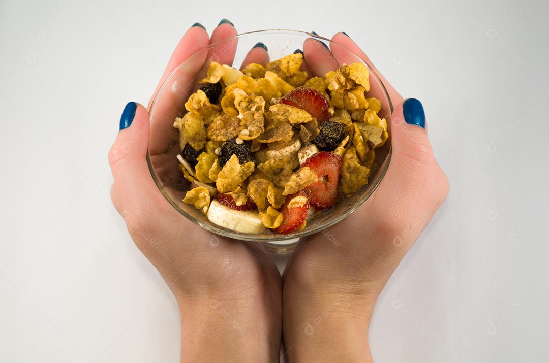 Woman's hand scooping up granola with spoon
