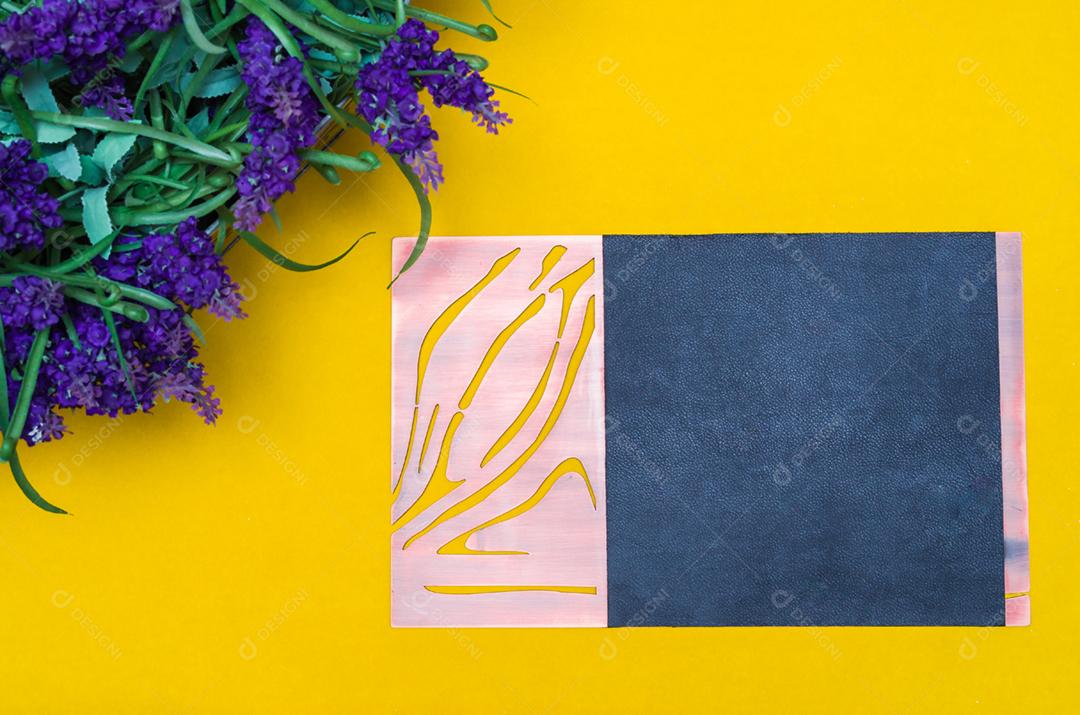 Vista aérea de um vaso de flores de lavanda em um fundo amarelo