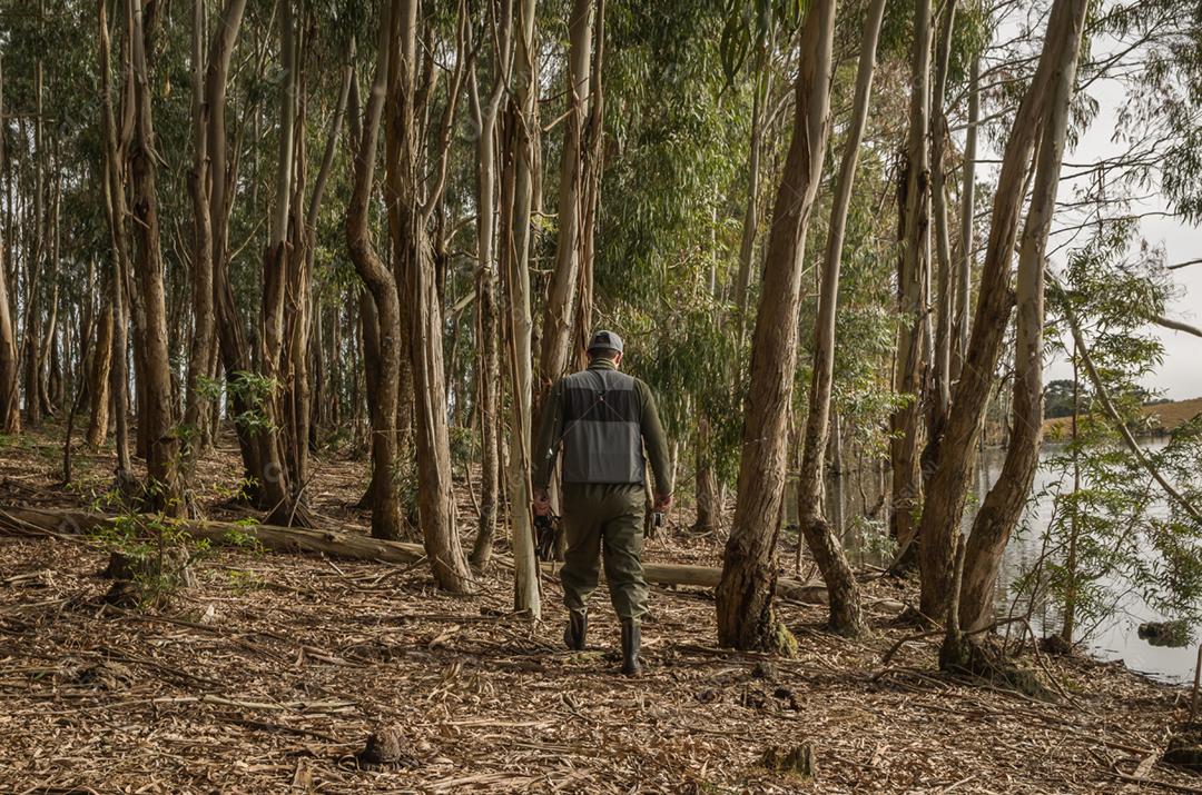 Pescador esportivo de pesca no lago em dia nublado