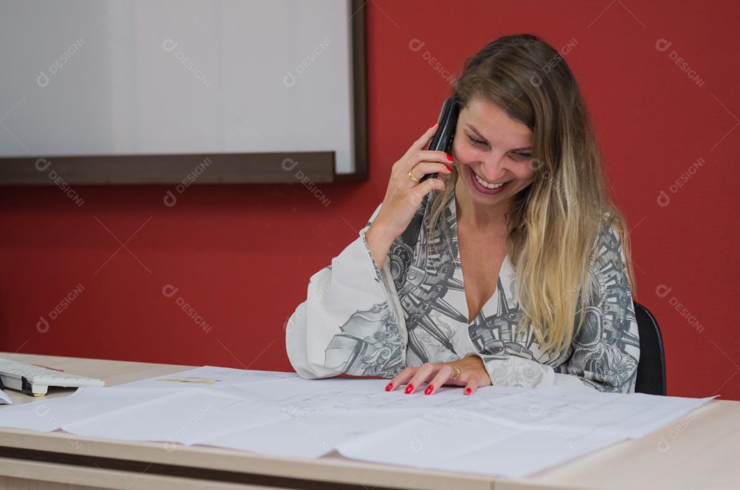 Great working desk concept, young man talking on cell phone in office.