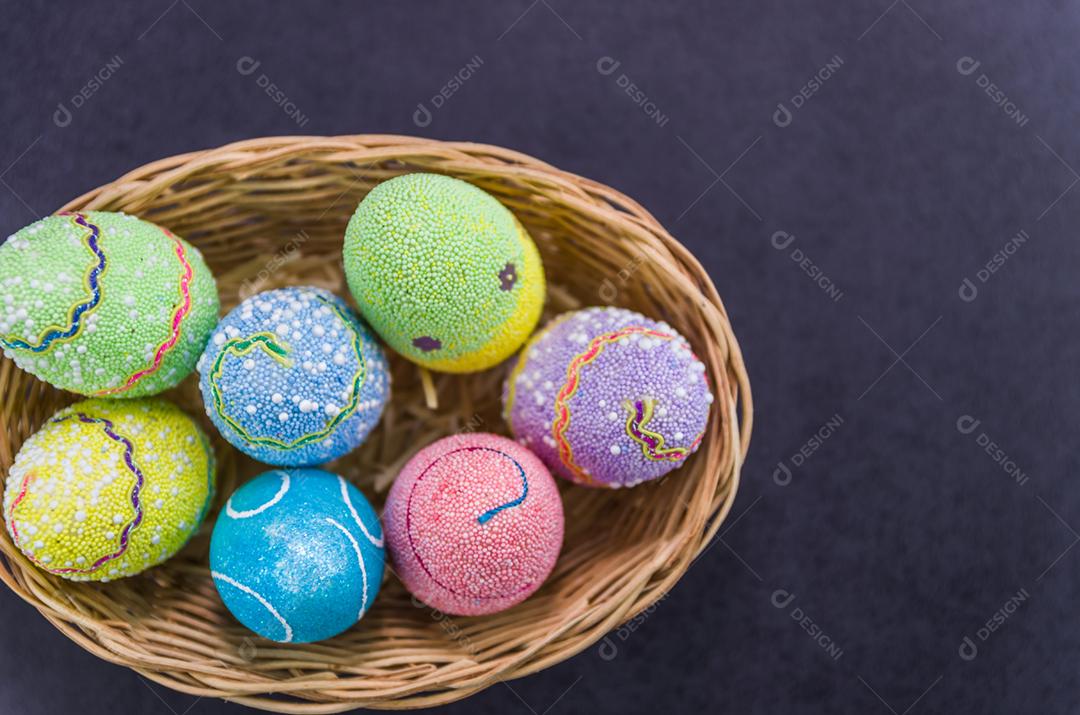 Ovos de Páscoa coloridos em um fundo preto na moda.