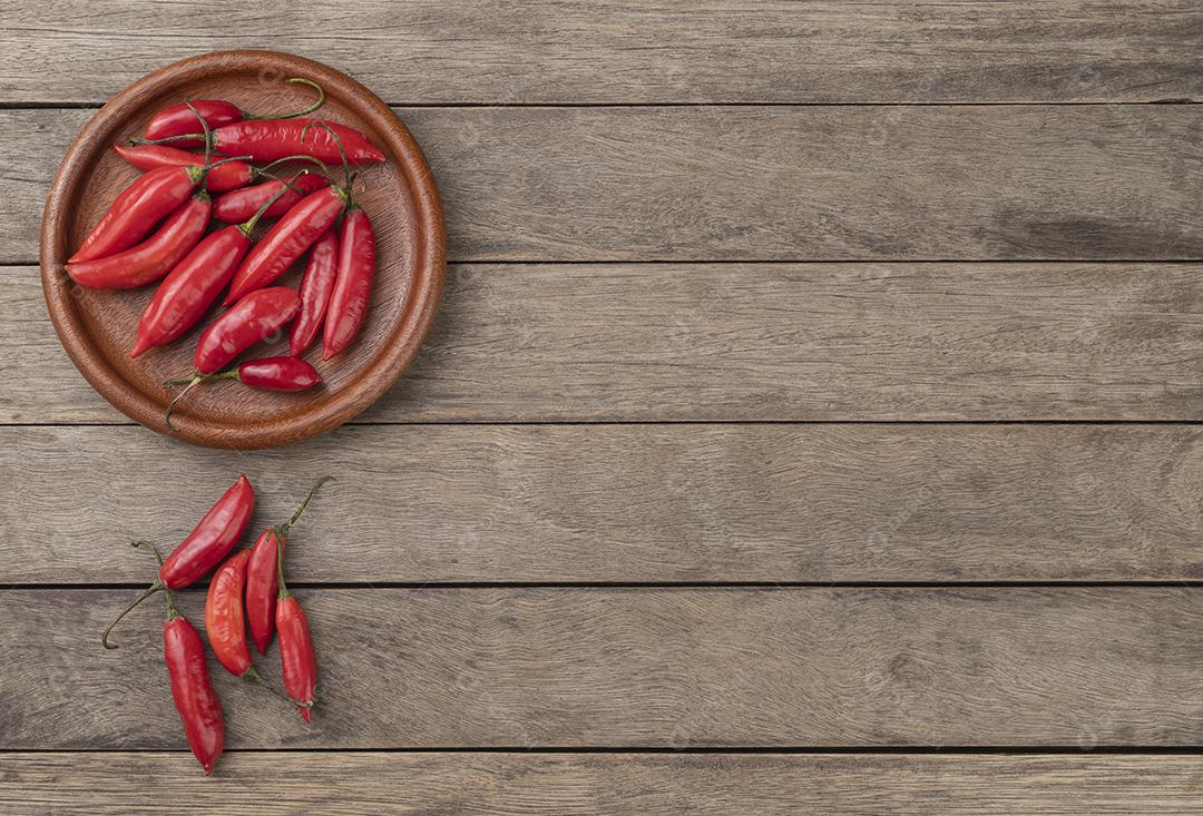 Pimentão vermelho em um prato sobre mesa de madeira