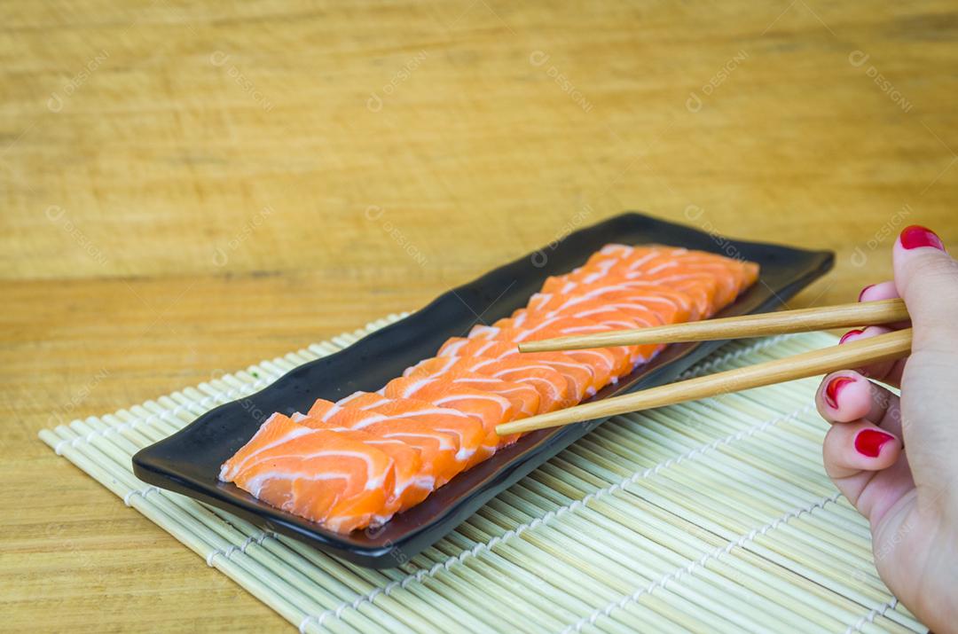 Traditional salmon carpaccio with olive oil sauce and lemon juice