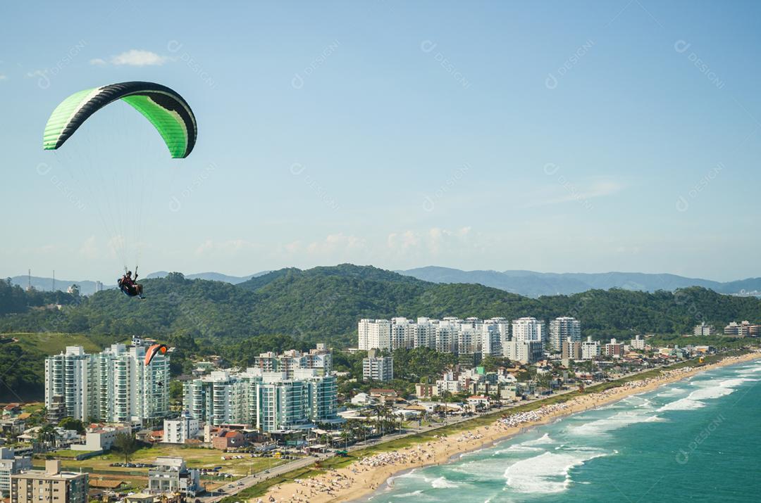 Students practicing paragliding on the hill.
