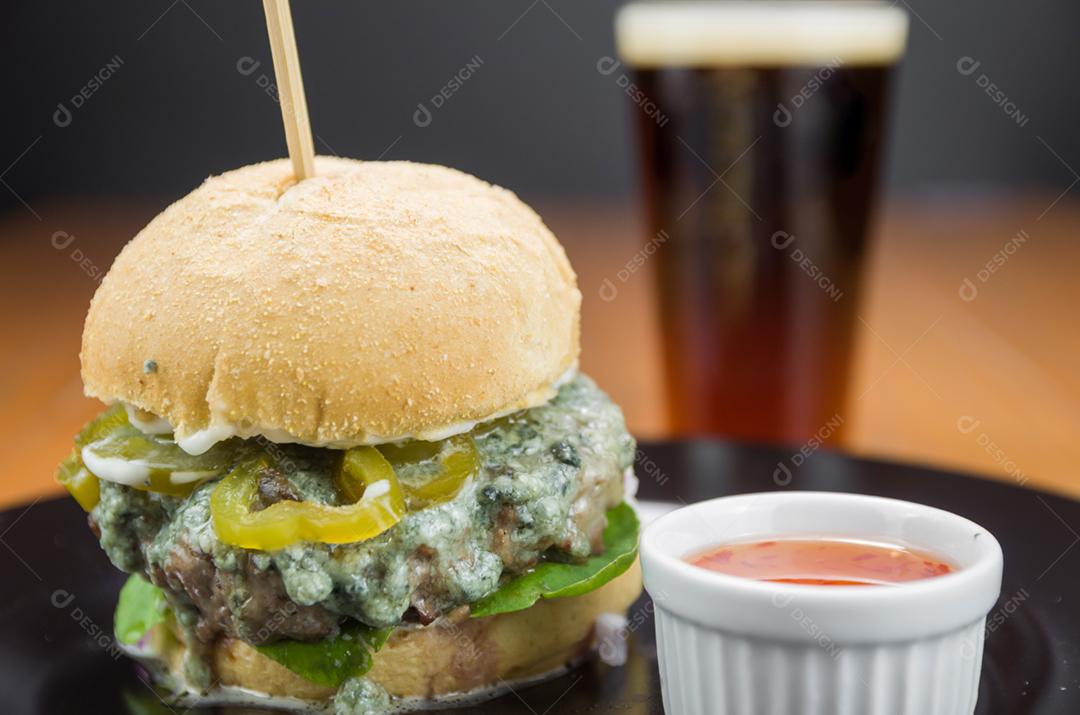 Tasty homemade hamburger on wooden table and black background