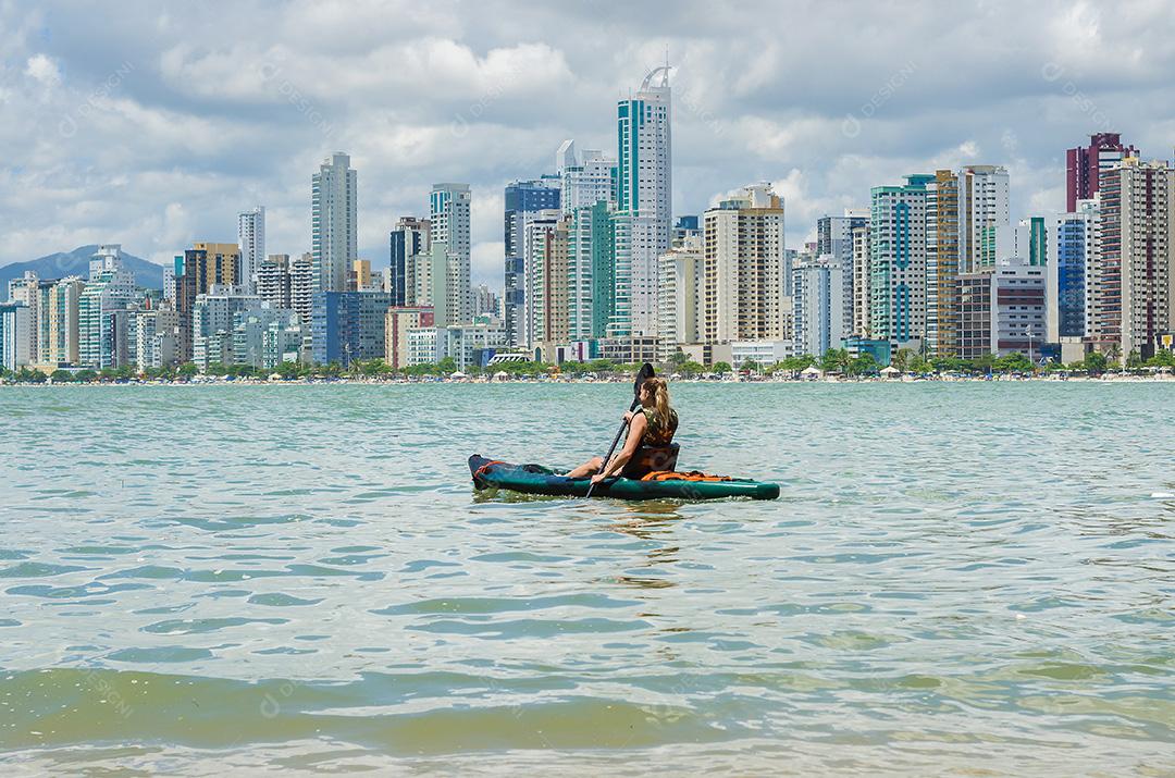Jovem passeando de caiaque na praia brasileira. Pesca de caiaque