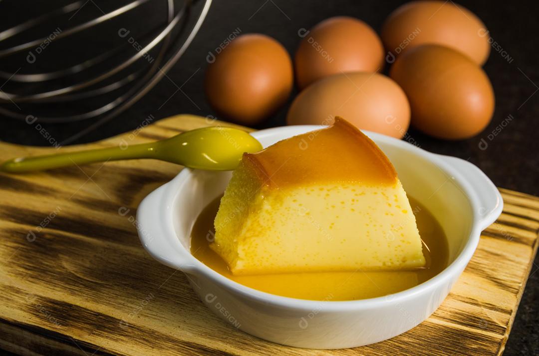 Delicious pudding, dessert made with eggs and milk, traditional Brazilian dessert, served with syrup