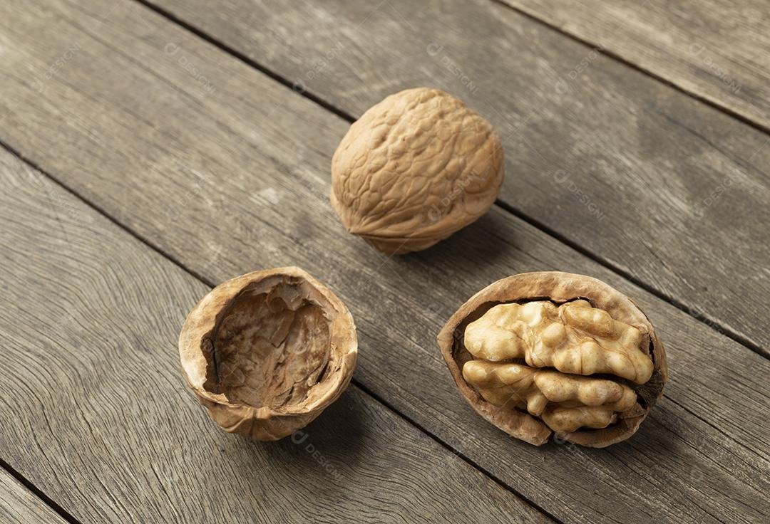 Nuts and open nut on a wooden table.