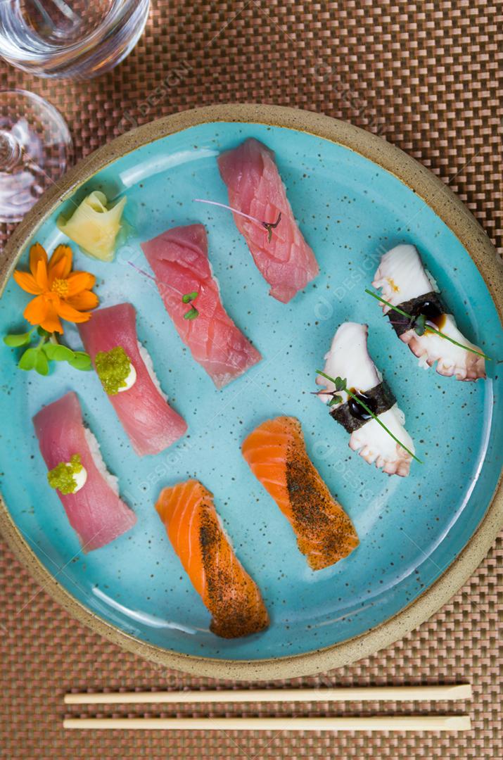 Assorted premium tuna and salmon nigiri sushi on a beautifully decorated plate.