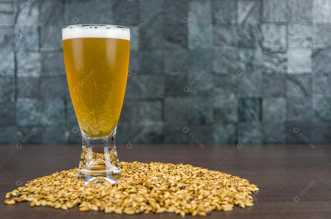 Beer glass seen from above with malt in the background