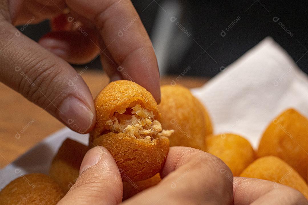 Salgadinho de frango sobre tigela branca.