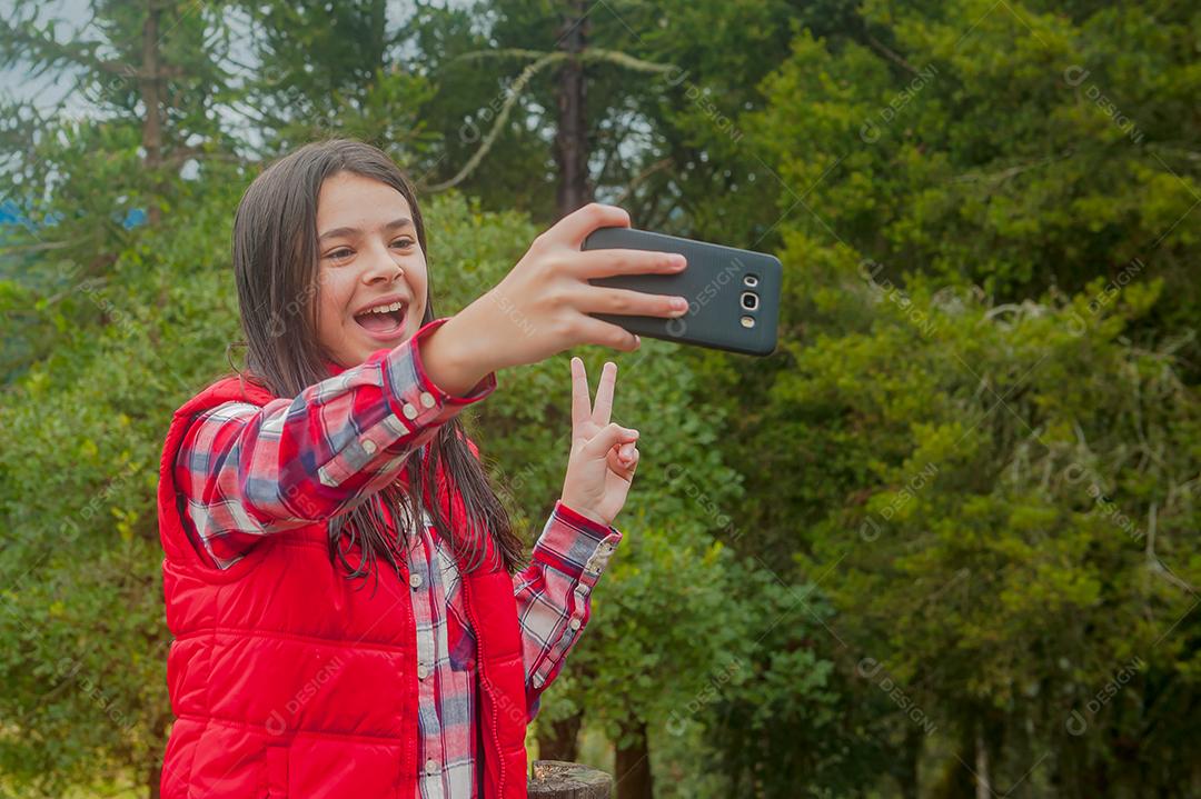 Beautiful young woman fiddling with her cell phone