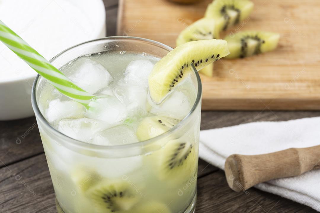 Brazilian kiwi caipirinha in a glass with ice and fruit slices