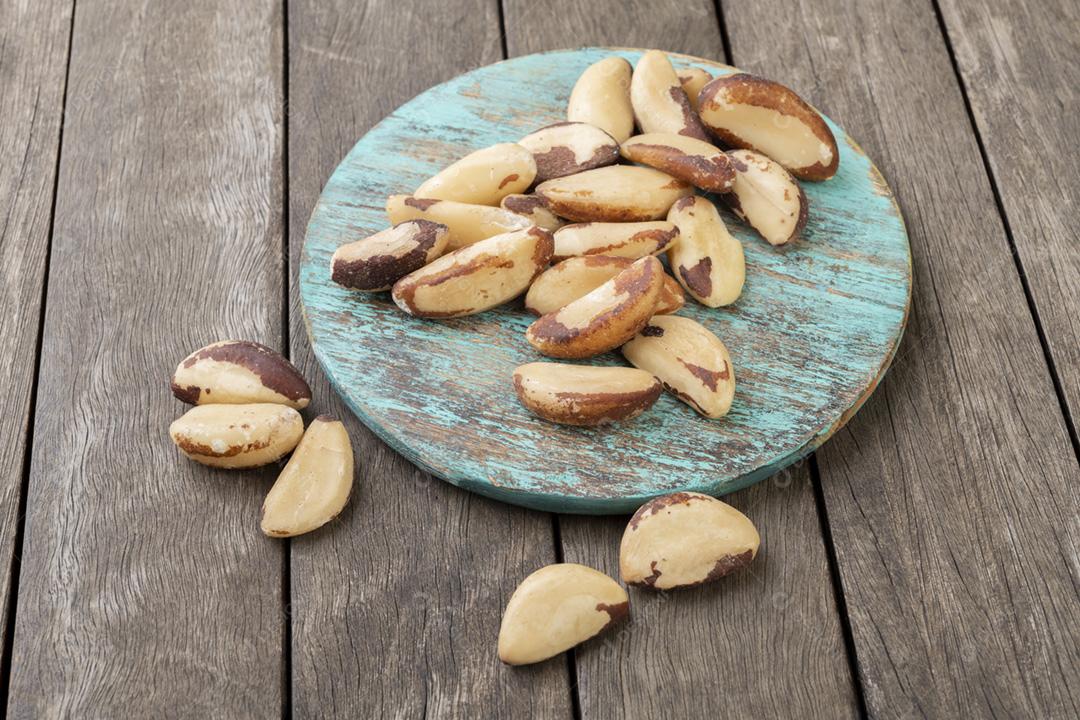 Castanhas do Brasil em uma placa sobre a mesa de madeira