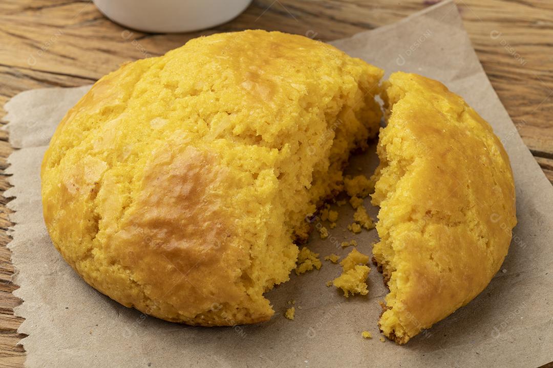 Broa, pão típico de farinha de milho brasileira sobre mesa de madeira.